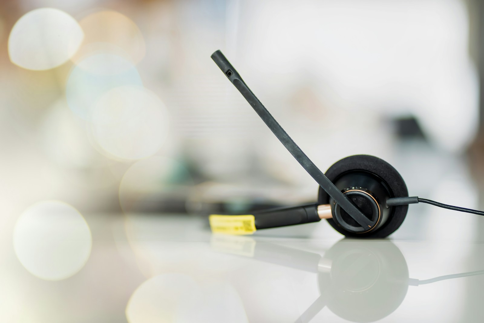 A pair of black headphones sitting on top of a table